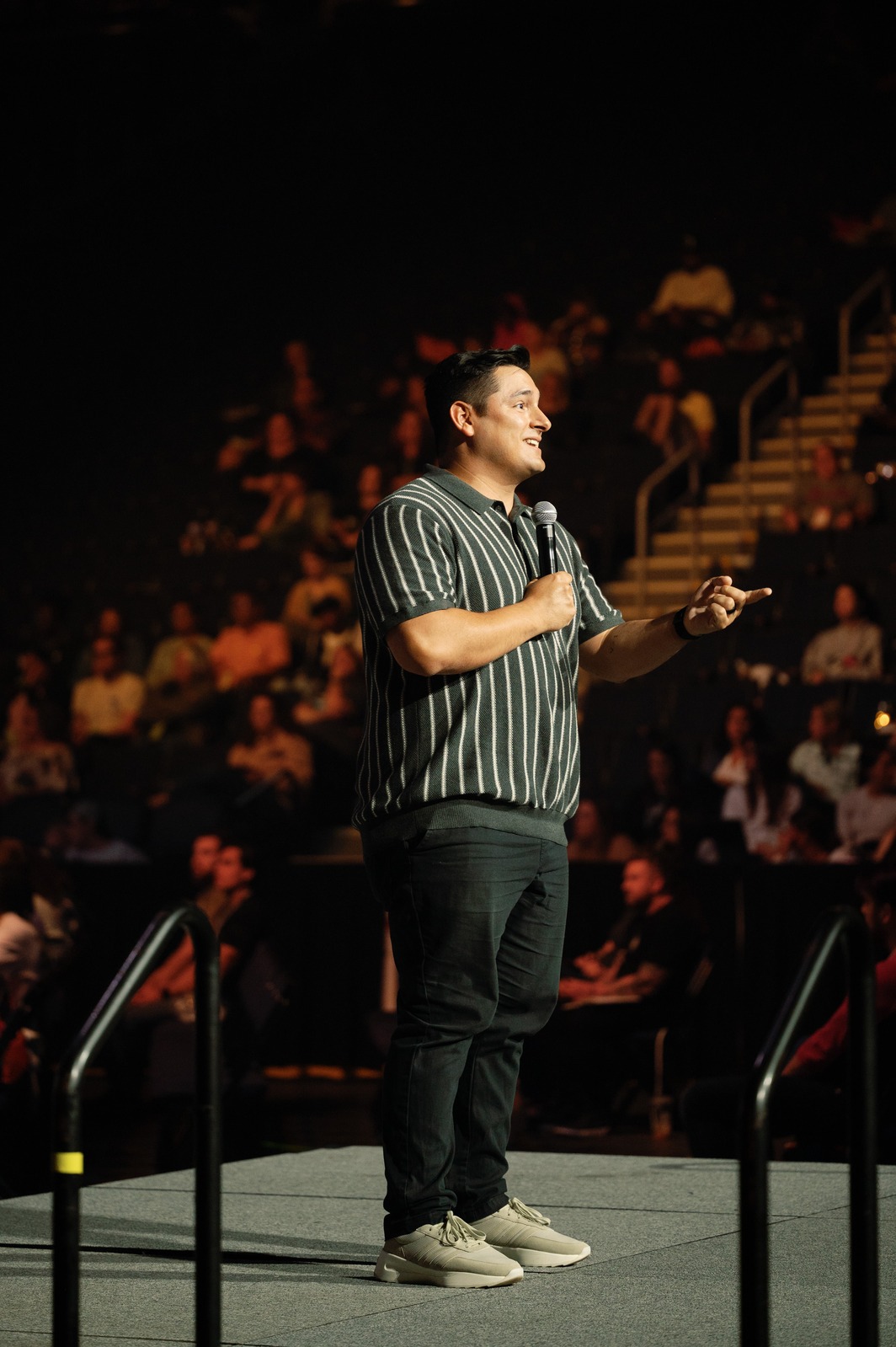 Shane Sanchez speaking with a microphone among an audience